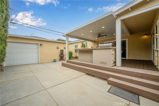 3113 San Anseline Ave, Long Beach, CA 90808 - exterior space with stucco siding, driveway, a garage, a ceiling fan, and an AC wall unit
