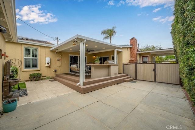 3113 San Anseline Ave, Long Beach, CA 90808 - rear view of house featuring stucco siding, ceiling fan, a patio, a gate, and a wooden deck