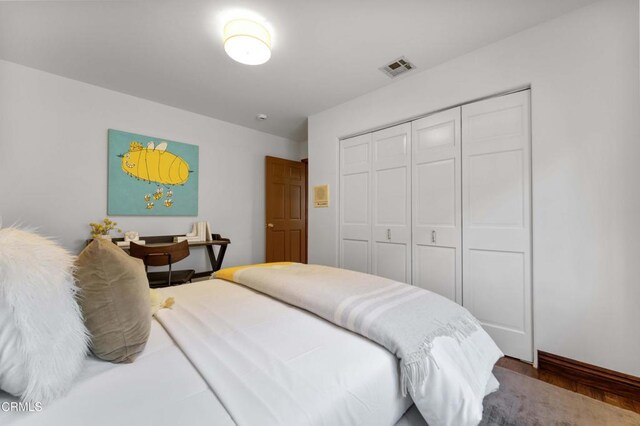 bedroom with a closet and wood finished floors