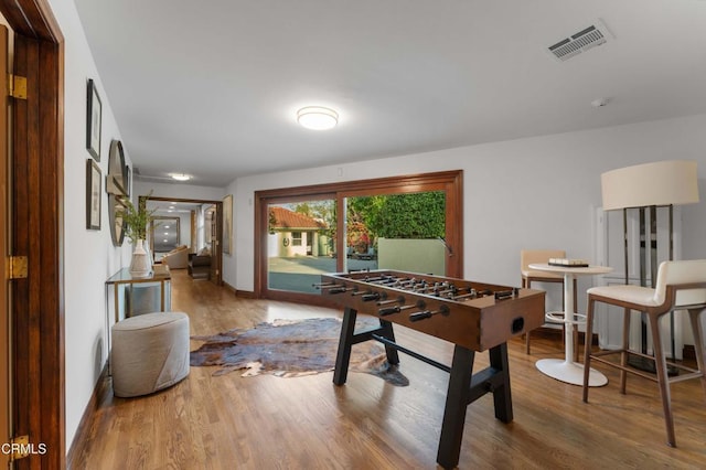 playroom with wood finished floors and baseboards
