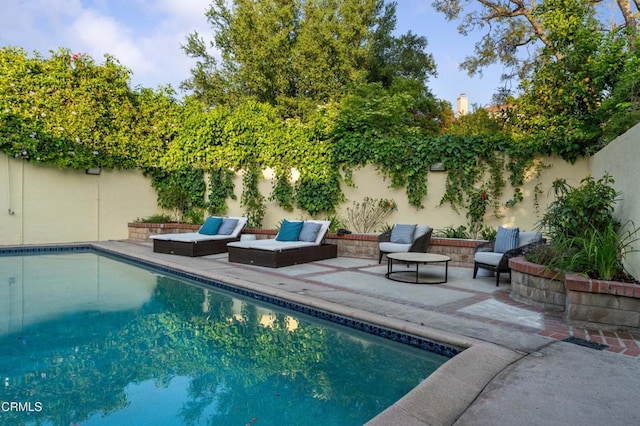 view of pool featuring a patio and a fenced backyard