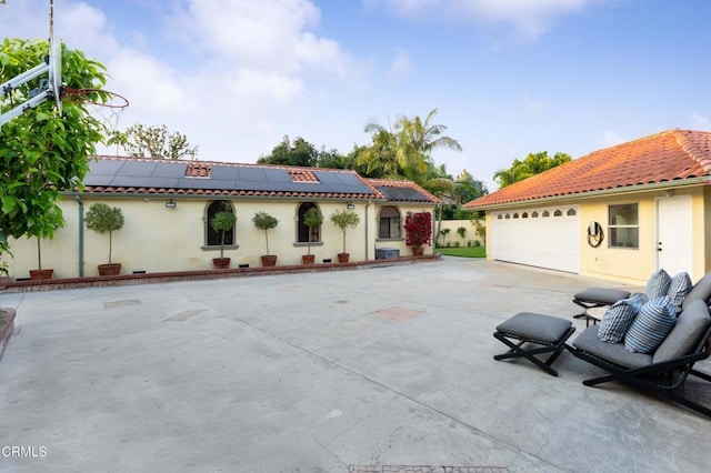 view of patio featuring a garage and driveway