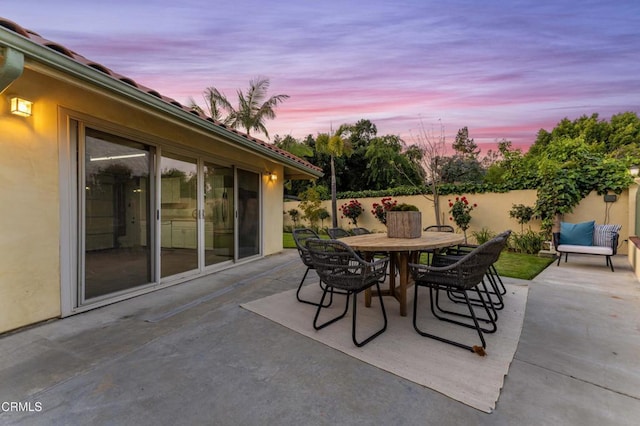 view of patio with a fenced backyard and outdoor dining area