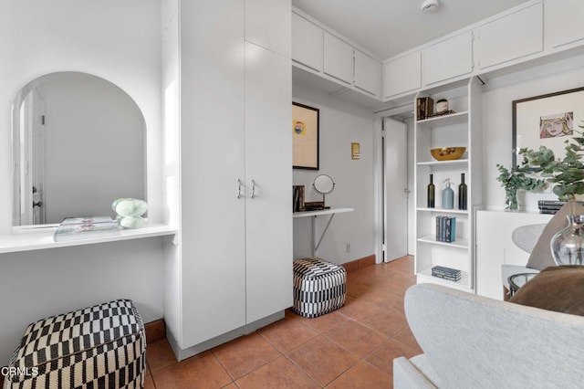 interior space with arched walkways and baseboards