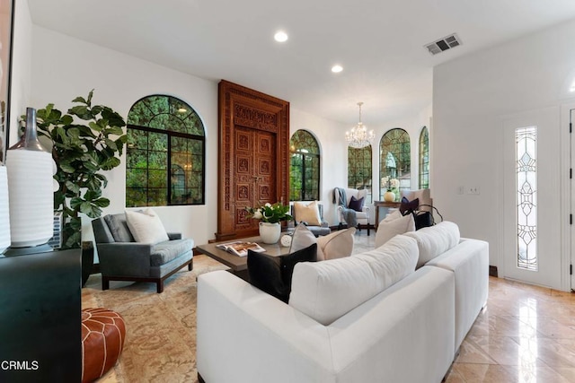 living room featuring a chandelier, healthy amount of natural light, and recessed lighting