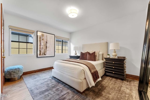 bedroom featuring baseboards and wood finished floors