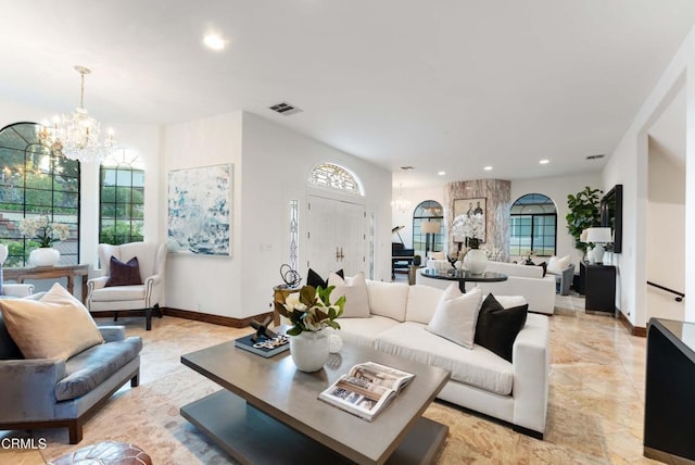 living room with a chandelier, recessed lighting, and baseboards