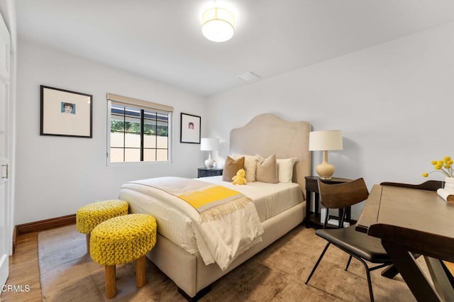 bedroom with wood finished floors and baseboards