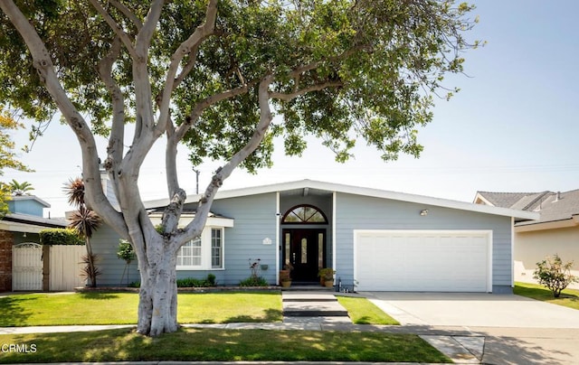12091 Pine St, Los Alamitos, CA 90720 - mid-century inspired home featuring an attached garage, driveway, and a front lawn