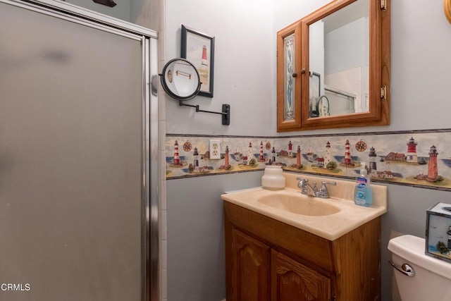 full bathroom with a shower stall, toilet, and vanity