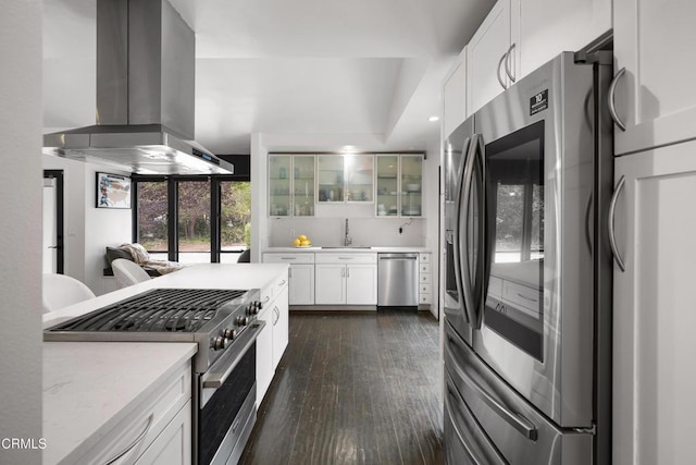 1445 Washburn Rd, Pasadena, CA 91105 - kitchen featuring appliances with stainless steel finishes, island range hood, glass insert cabinets, dark wood-style floors, and white cabinetry