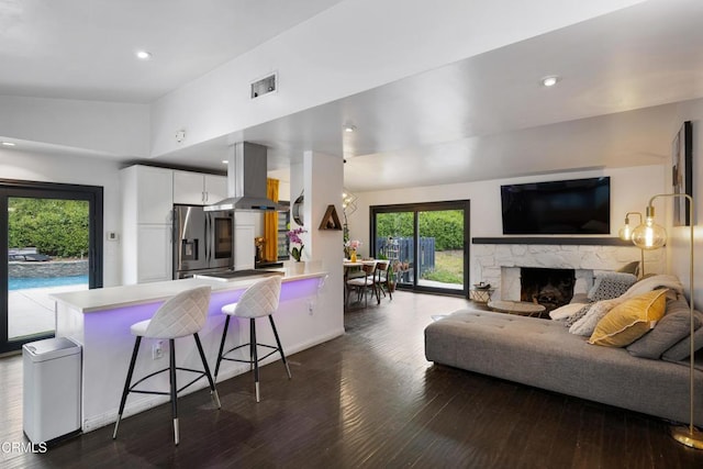 1445 Washburn Rd, Pasadena, CA 91105 - living area featuring dark wood finished floors, a fireplace, lofted ceiling, recessed lighting, and baseboards
