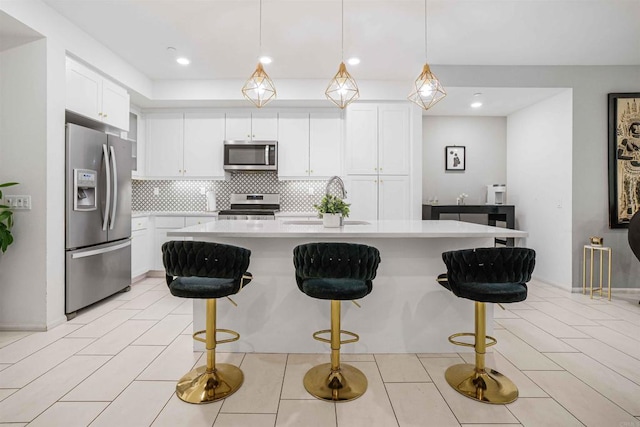 1445 Suwerte Ave Unit 4, Chula Vista, CA 91915 - kitchen featuring stainless steel appliances, a sink, light countertops, decorative backsplash, and white cabinetry