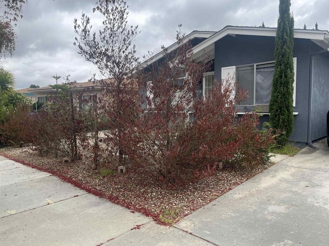 view of side of property featuring stucco siding