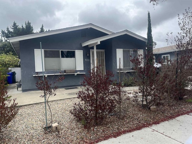 ranch-style home with stucco siding
