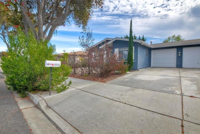 3113 Buena Hills Dr, Oceanside, CA 92056 - view of home's exterior featuring a garage, concrete driveway, and stucco siding