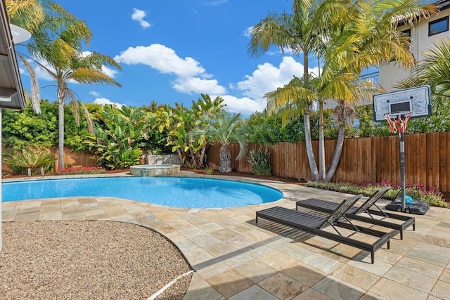 view of swimming pool featuring a fenced backyard, a patio area, and a pool with connected hot tub
