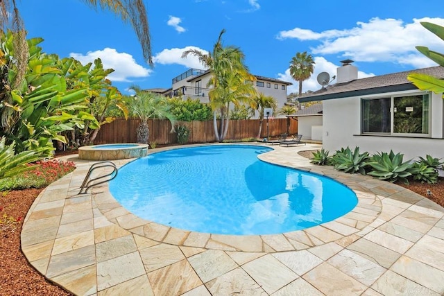 view of swimming pool featuring a fenced backyard, a patio area, and a pool with connected hot tub