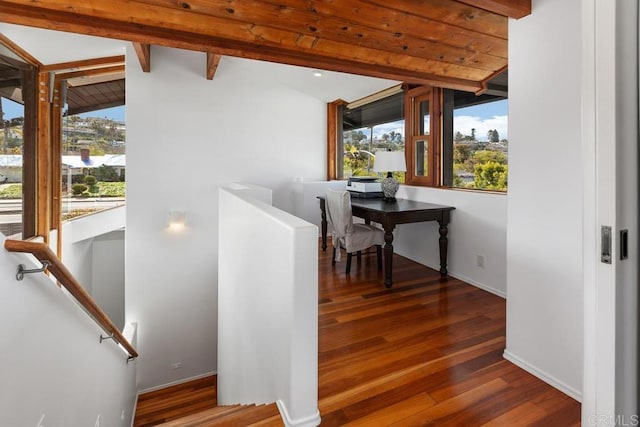 stairs featuring plenty of natural light, wood finished floors, and baseboards