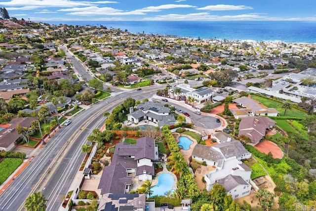 aerial view of property's location with nearby suburban area, a pool area, a nearby body of water, and a major roadway