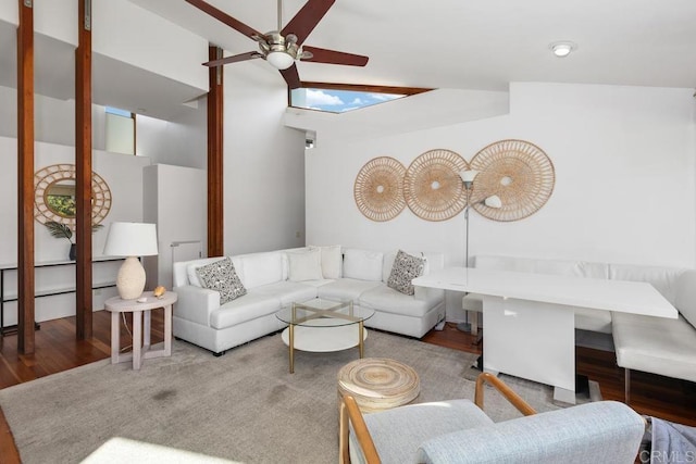 living area with a ceiling fan and wood finished floors