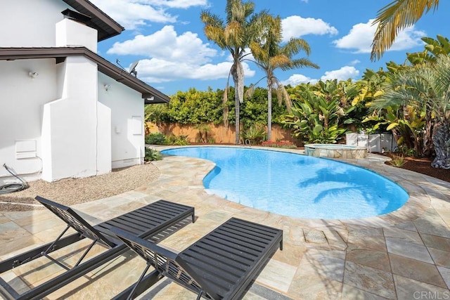 view of swimming pool with a fenced backyard, a patio area, and a pool with connected hot tub
