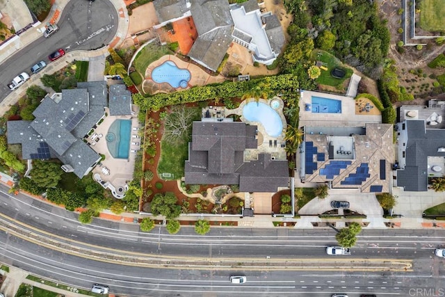 aerial view of property and surrounding area featuring a pool