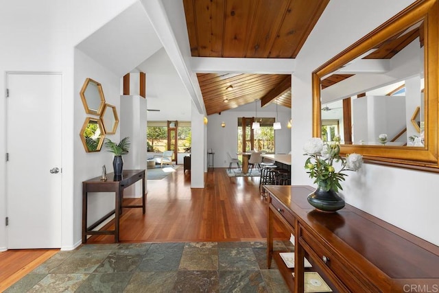 entryway featuring wooden ceiling, stone finish floors, and baseboards