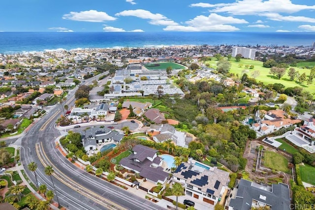 aerial overview of property's location with a nearby body of water and nearby suburban area