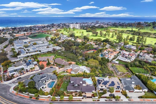 aerial view of property's location featuring a nearby body of water and nearby suburban area