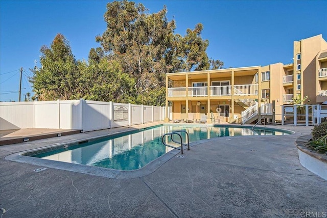 view of pool with fence and a patio area