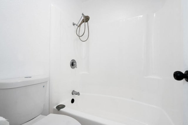 bathroom with toilet and  shower combination