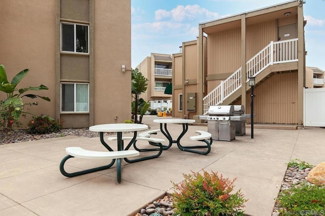 view of property's community featuring a patio area and stairs