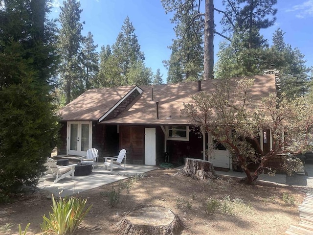 25860 Oakwood St, Idyllwild, CA 92549 - back of house featuring french doors, an outdoor fire pit, a patio area, and roof with shingles