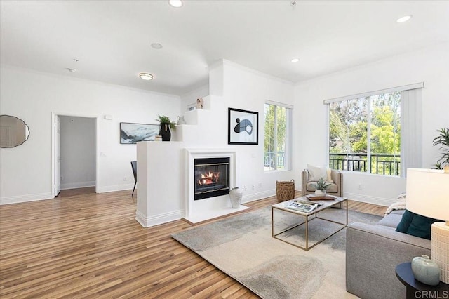 12370 Carmel Country Rd Unit 305, San Diego, CA 92130 - living area with wood finished floors, baseboards, crown molding, a fireplace with flush hearth, and recessed lighting