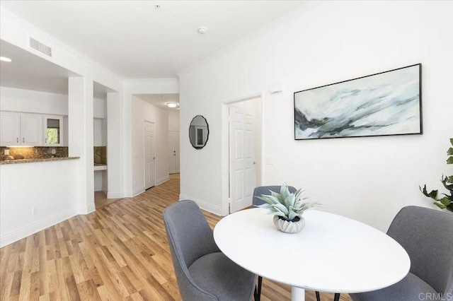12370 Carmel Country Rd Unit 305, San Diego, CA 92130 - dining area with light wood-type flooring and crown molding