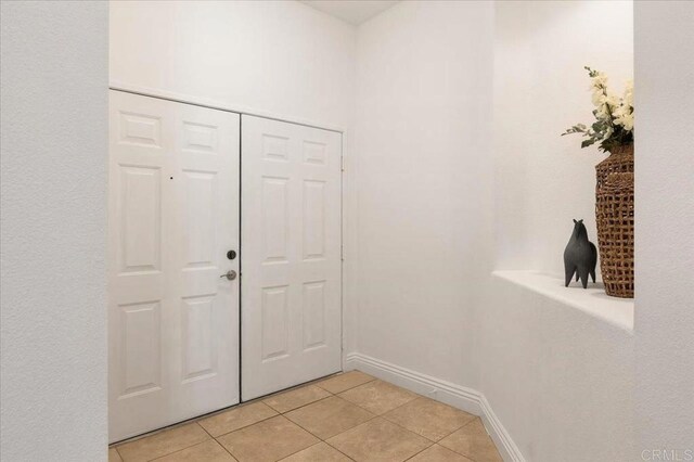 12370 Carmel Country Rd Unit 305, San Diego, CA 92130 - foyer entrance featuring light tile patterned floors and baseboards