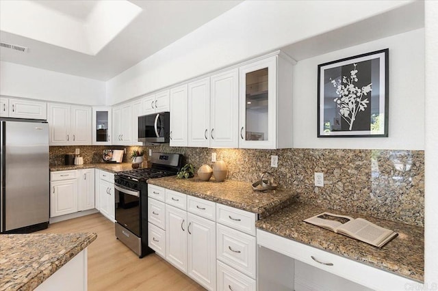 12370 Carmel Country Rd Unit 305, San Diego, CA 92130 - kitchen featuring appliances with stainless steel finishes, white cabinetry, light wood finished floors, and glass insert cabinets