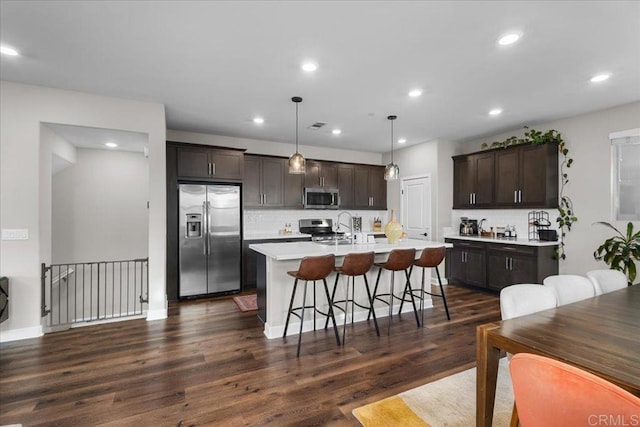 1840 Mint Unit 6, Chula Vista, CA 91915 - kitchen featuring stainless steel appliances, dark brown cabinets, light countertops, decorative backsplash, and dark wood-style flooring