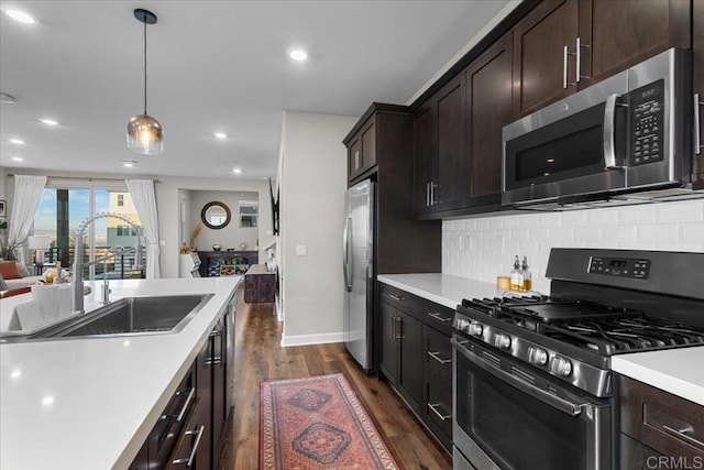1840 Mint Unit 6, Chula Vista, CA 91915 - kitchen featuring appliances with stainless steel finishes, dark wood-style flooring, light countertops, backsplash, and recessed lighting