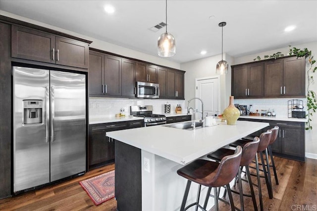 1840 Mint Unit 6, Chula Vista, CA 91915 - kitchen with appliances with stainless steel finishes, dark wood-type flooring, dark brown cabinetry, decorative backsplash, and recessed lighting