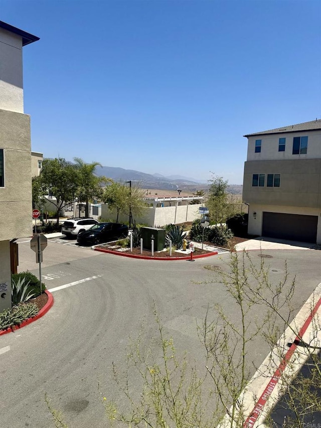 1840 Mint Unit 6, Chula Vista, CA 91915 - view of asphalt road featuring traffic signs, curbs, and a mountain view