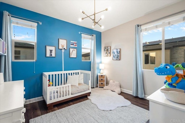 1840 Mint Unit 6, Chula Vista, CA 91915 - bedroom with a nursery area, multiple windows, wood finished floors, and a chandelier