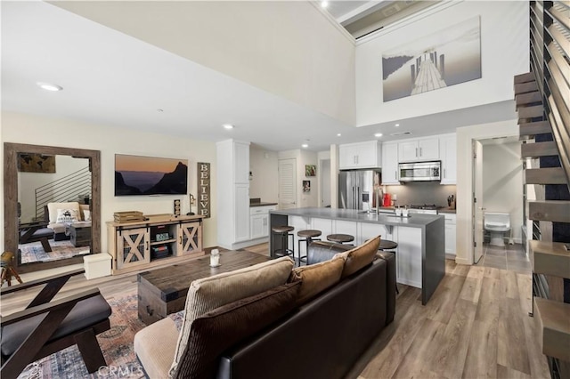 living room featuring light wood-type flooring and recessed lighting