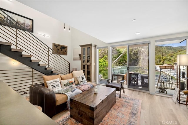 living room with wood finished floors and stairway