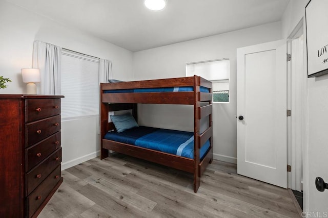 bedroom featuring wood finished floors and baseboards