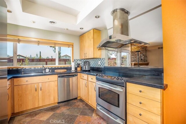 24111 Marathon St, Mission Viejo, CA 92691 - kitchen featuring stainless steel appliances, wall chimney exhaust hood, a sink, dark countertops, and plenty of natural light