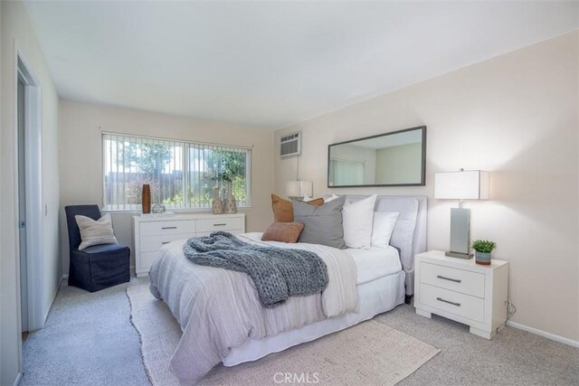 24111 Marathon St, Mission Viejo, CA 92691 - bedroom featuring light colored carpet, a wall unit AC, and baseboards