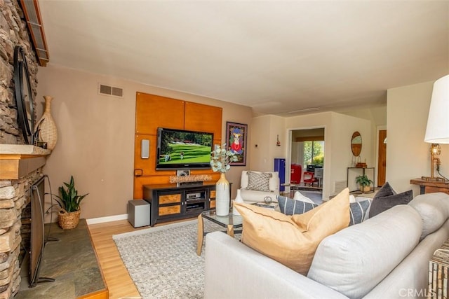 24111 Marathon St, Mission Viejo, CA 92691 - living area featuring a fireplace, light wood finished floors, and baseboards