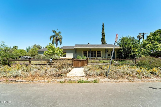 ranch-style home featuring a fenced front yard
